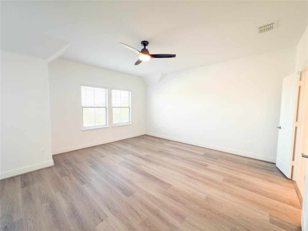 114 Settlers Way Euless, TX 76040 - Photo 18 of 38 an empty room with wooden floor cabinet and windows