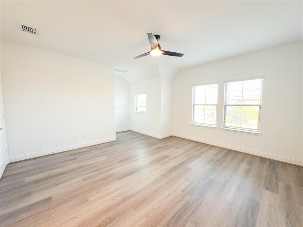 114 Settlers Way Euless, TX 76040 - Photo 20 of 38 wooden floor in an empty room with a window