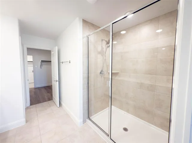 a bathroom with a glass shower door