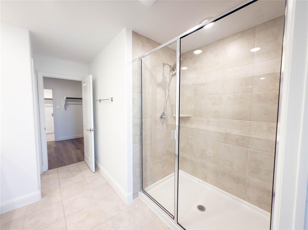 114 Settlers Way Euless, TX 76040 - Photo 23 of 38 a bathroom with a glass shower door