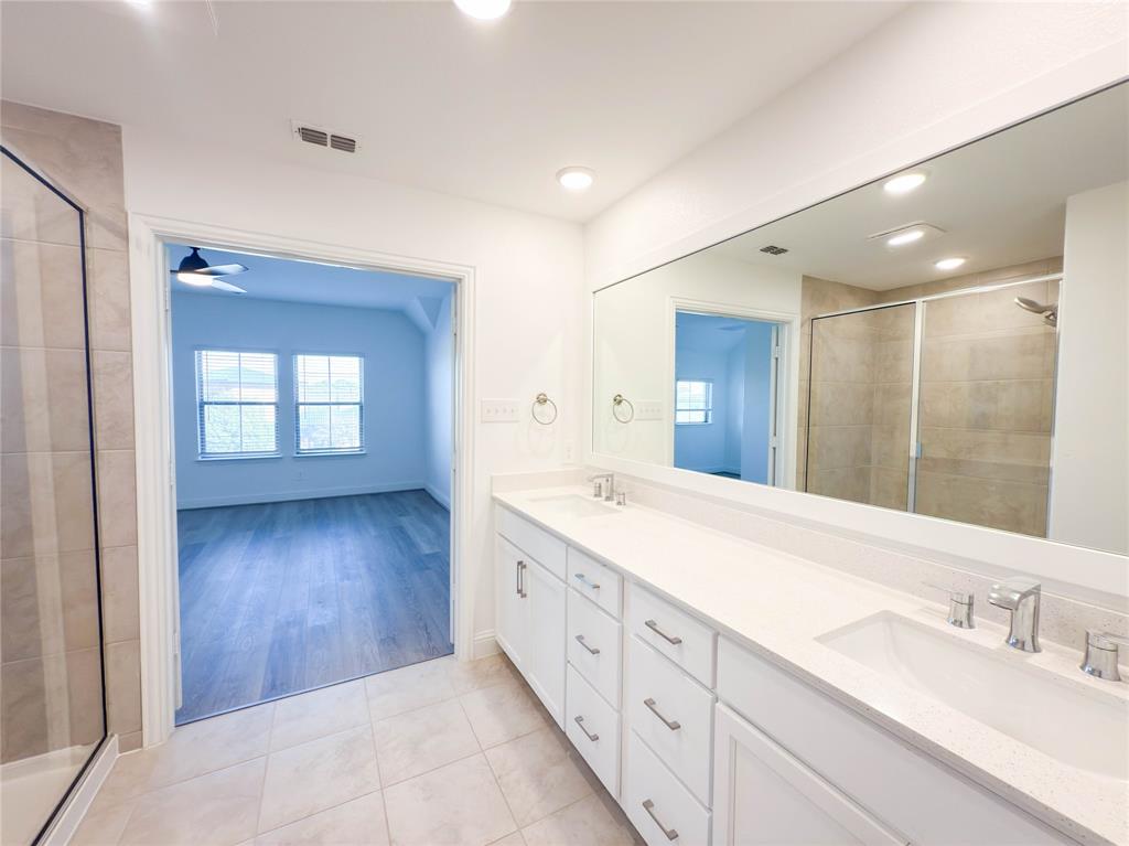 114 Settlers Way Euless, TX 76040 - Photo 24 of 38 a spacious bathroom with a double vanity sink and a mirror