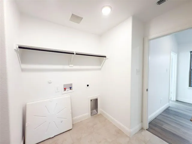 a utility room with cabinets washer and dryer