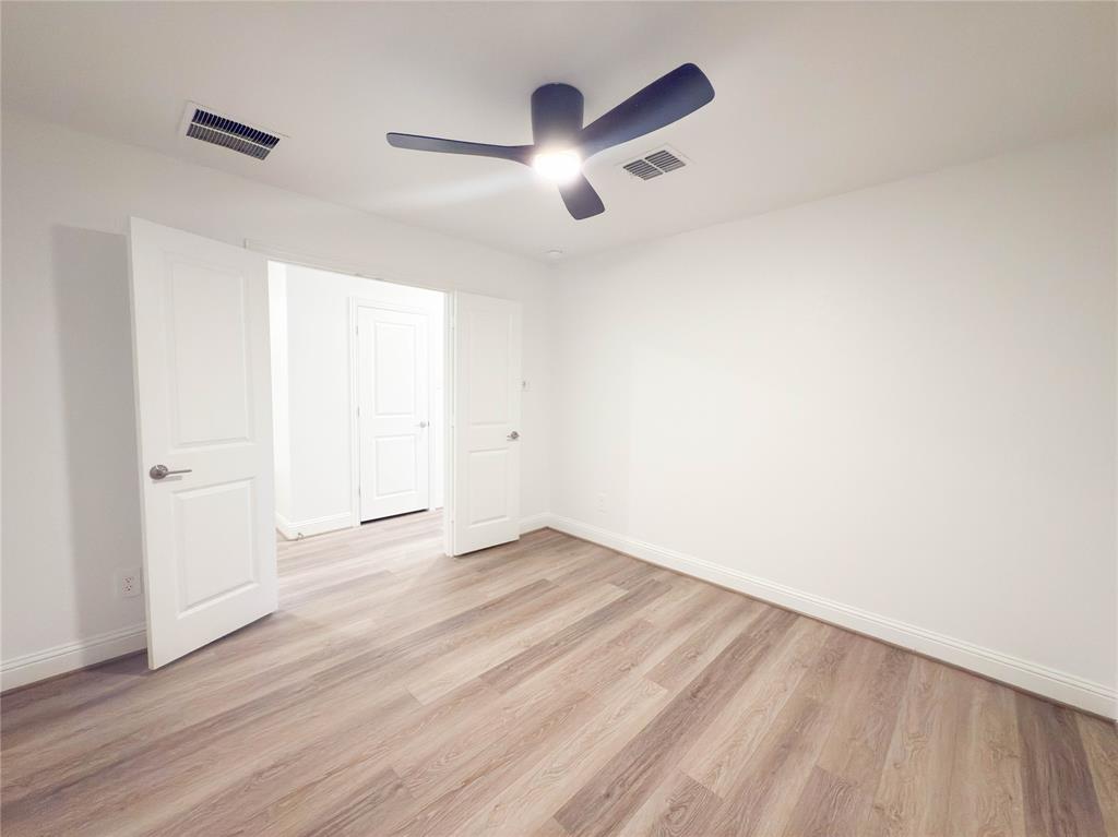 114 Settlers Way Euless, TX 76040 - Photo 34 of 38 an empty room with wooden floor and chandelier fan