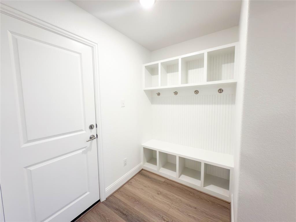 114 Settlers Way Euless, TX 76040 - Photo 36 of 38 a view of an empty room with wooden floor and closet