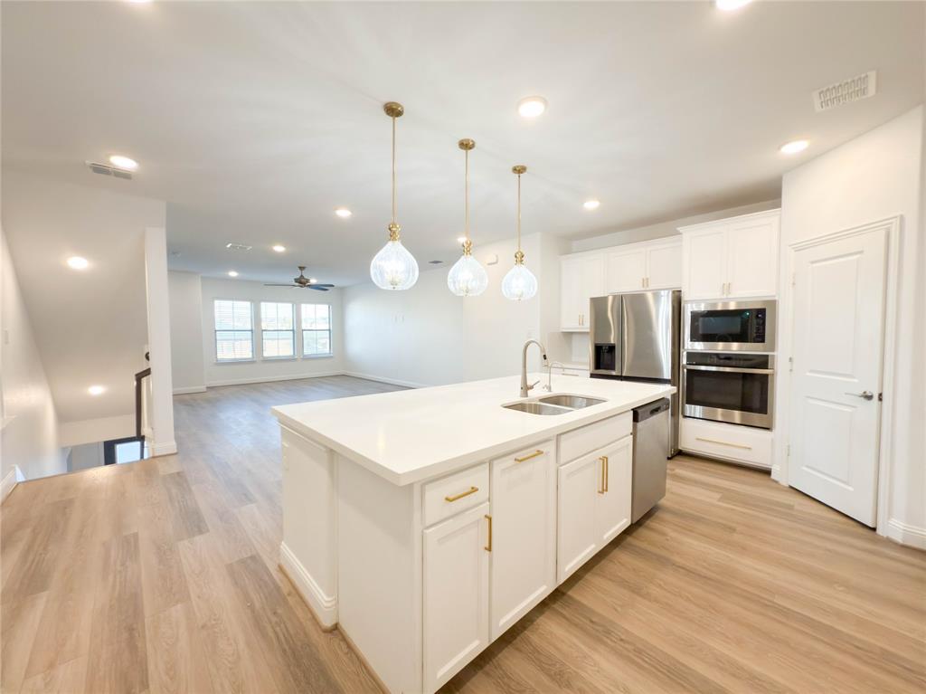 114 Settlers Way Euless, TX 76040 - Photo 7 of 38 a large white kitchen with a large counter top appliances and cabinets