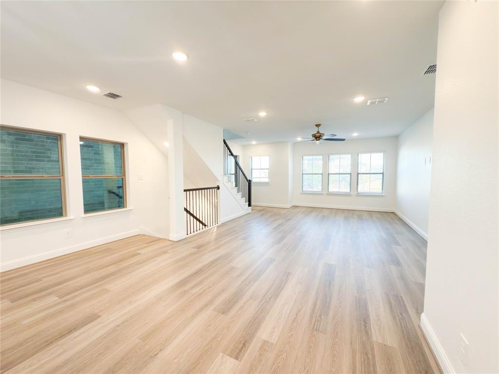 114 Settlers Way Euless, TX 76040 - Photo 10 of 38 a view of an empty room with wooden floor and a window