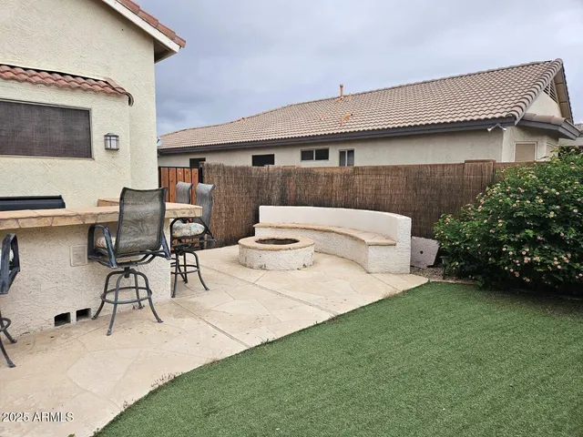a bedroom with a bed a table and chair