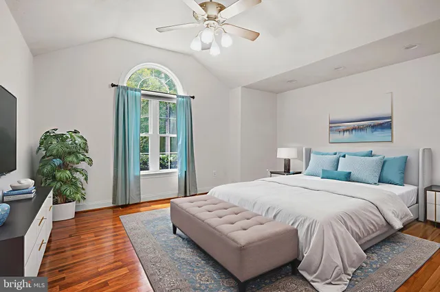 a spacious bedroom with a bed and a chandelier