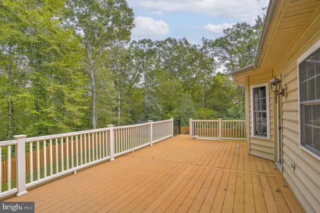 a view of a balcony with wooden floor and fence