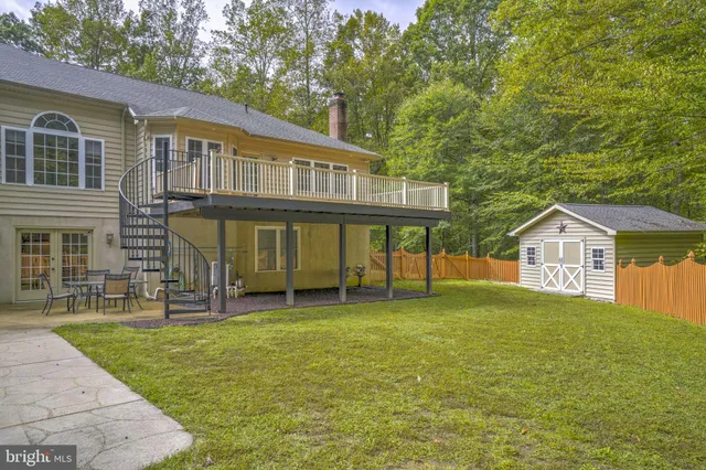 a view of a house with a yard balcony and sitting area
