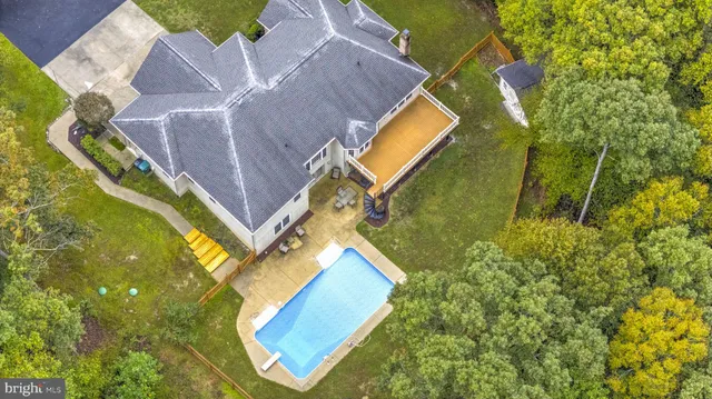 an aerial view of a house with swimming pool