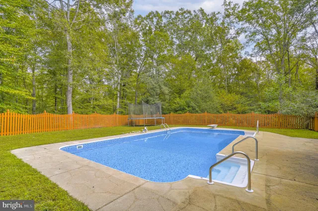 a view of a swimming pool with an outdoor space and seating area
