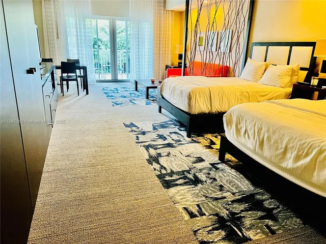 a bed room with two beds and a large window