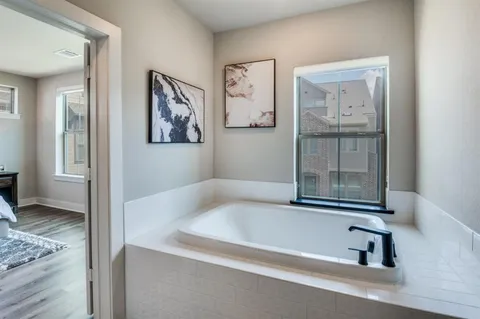 a bathroom with a tub and shower