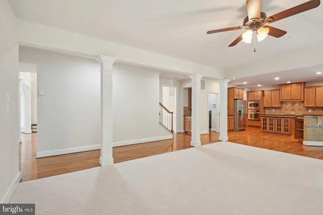 a view of a kitchen with wooden floor and electronic appliances