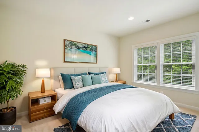 a view of an empty room with wooden floor and entryway