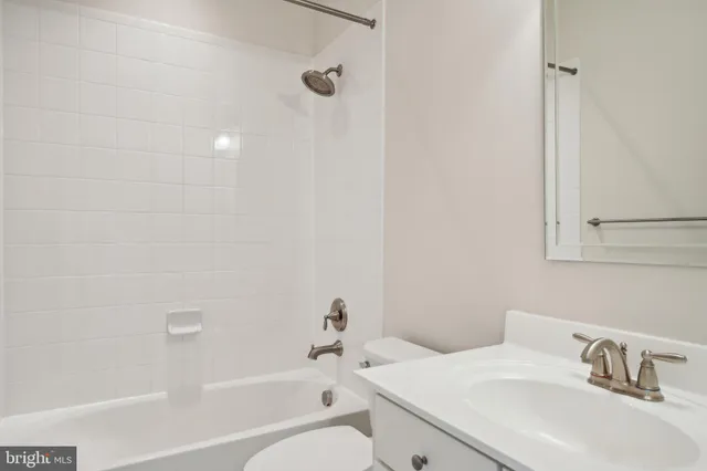 a living room with couches and painted wall with wooden floor