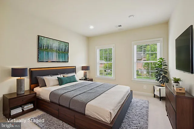 a front view of a house with a garden and yard