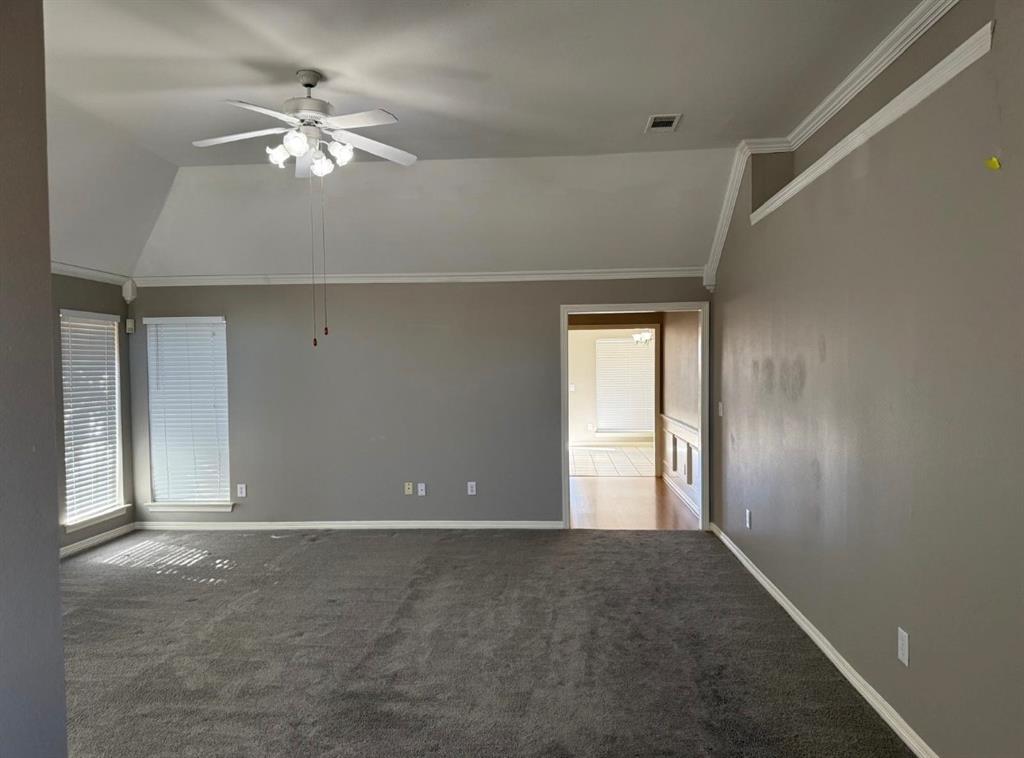 8001 Kings Ridge Road Frisco, TX 75035 - Photo 6 of 13 Unfurnished room with lofted ceiling, crown molding, ceiling fan, and carpet