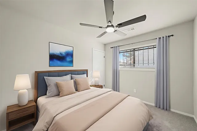 a bedroom with a bed and a painting on the wall