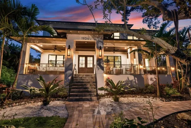 a view of a patio with table and chairs potted plants and palm tree