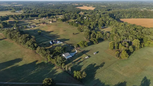 an aerial view of a house with a lake view