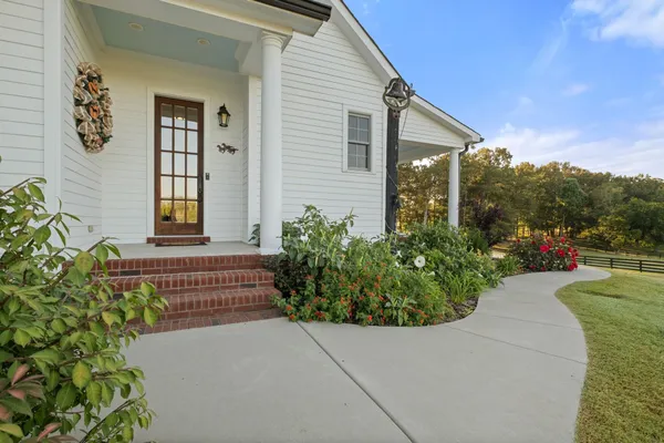 a front view of a house with a yard table and chairs