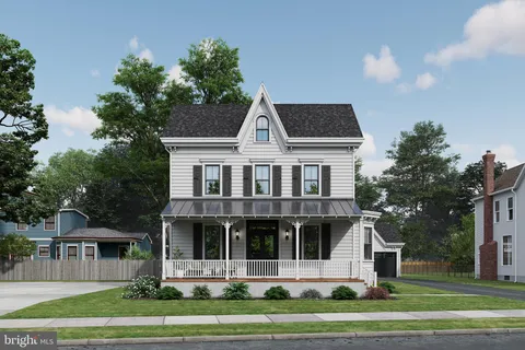 a view of a big house with a yard and large trees