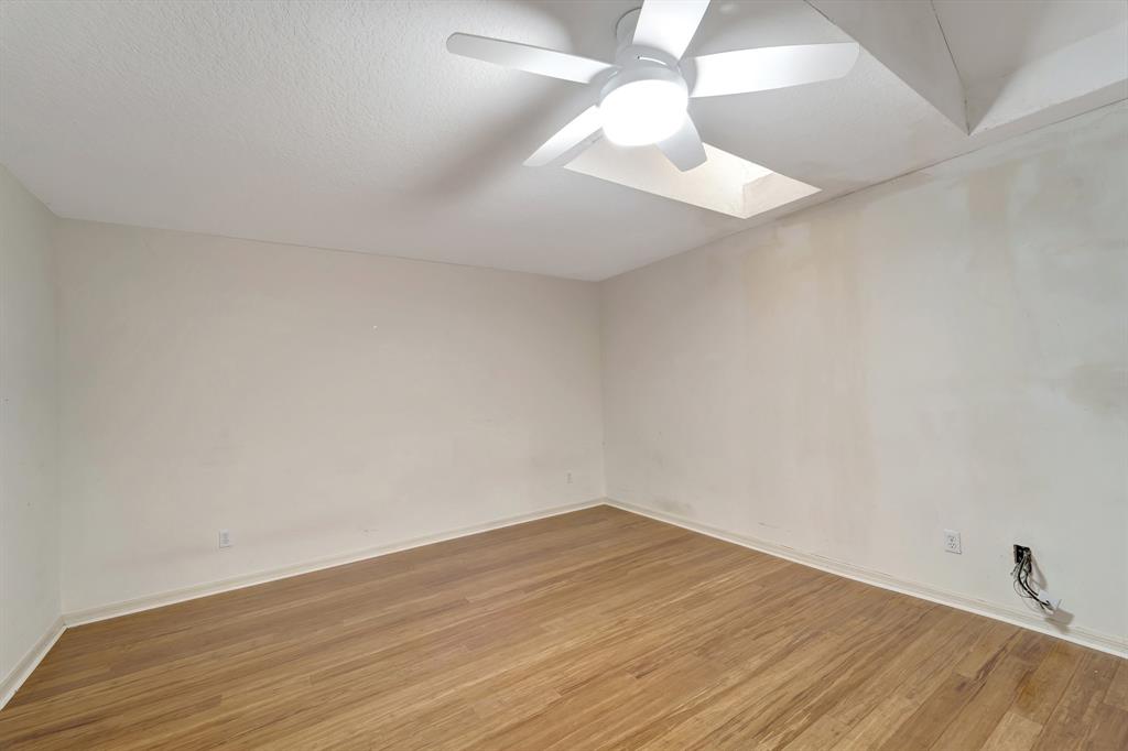 8040 Conservatory Circle Sarasota, FL 34243 - Photo 19 of 52 an empty room with wooden floor and fan
