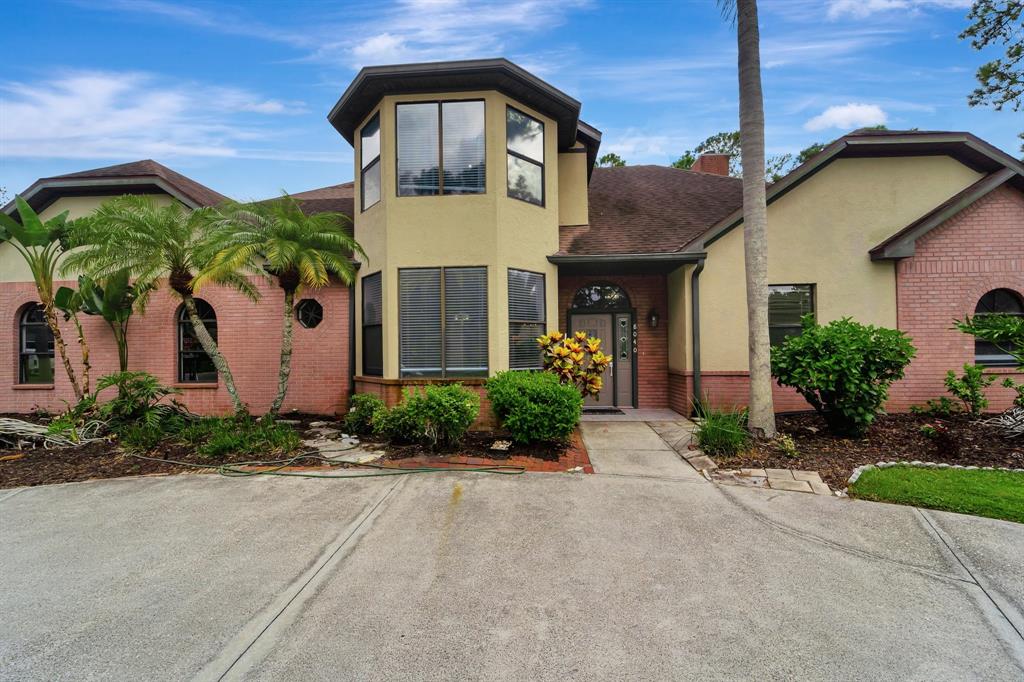 8040 Conservatory Circle Sarasota, FL 34243 - Photo 2 of 52 a front view of a house with garden