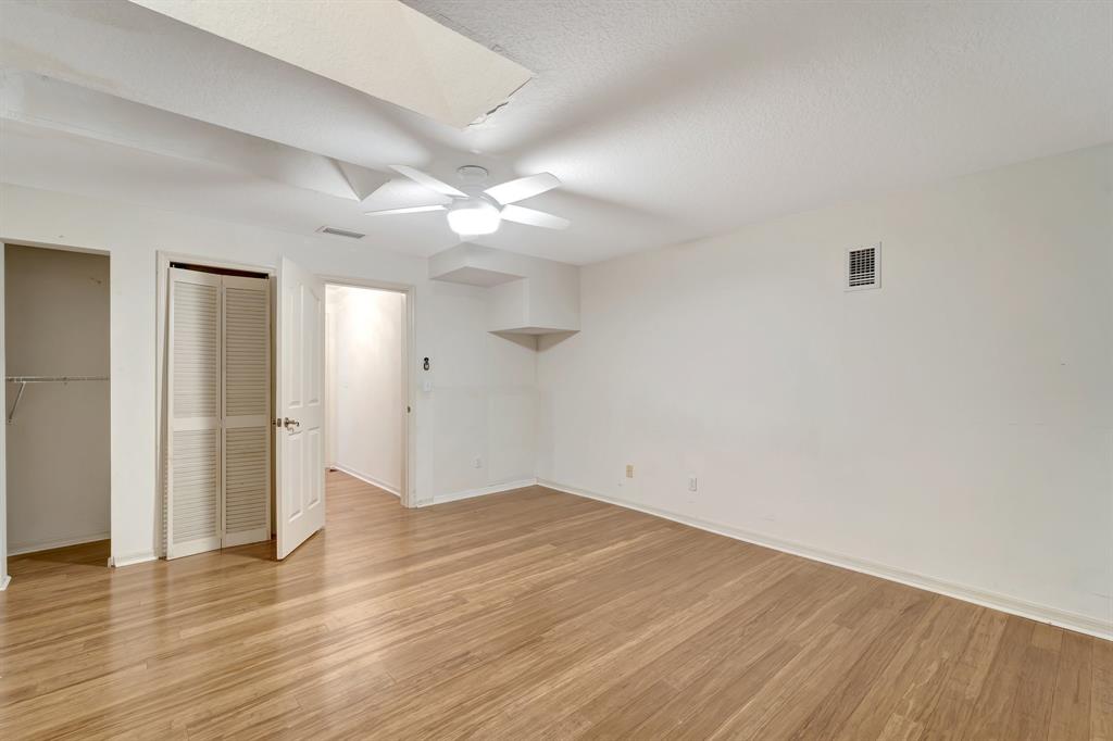 8040 Conservatory Circle Sarasota, FL 34243 - Photo 21 of 52 an empty room with wooden floor and fan