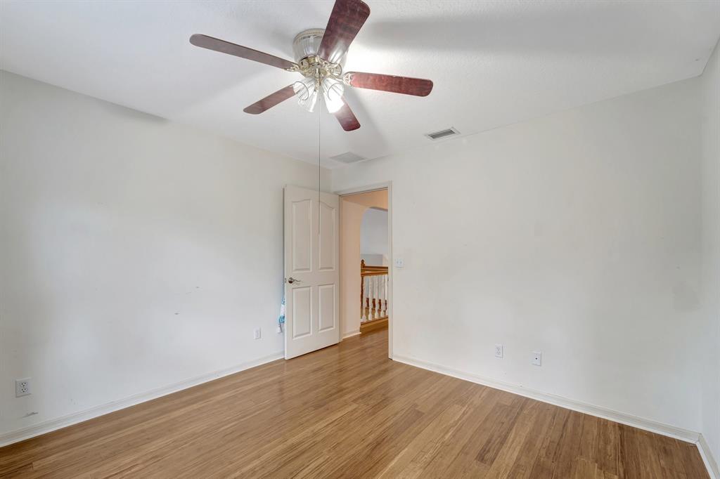 8040 Conservatory Circle Sarasota, FL 34243 - Photo 25 of 52 an empty room with wooden floor chandelier fan and closet area