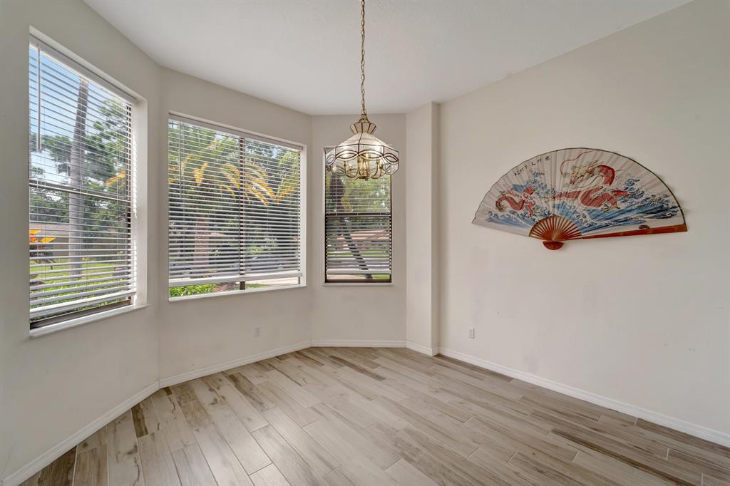 8040 Conservatory Circle Sarasota, FL 34243 - Photo 27 of 52 a view of an empty room with wooden floor and a window