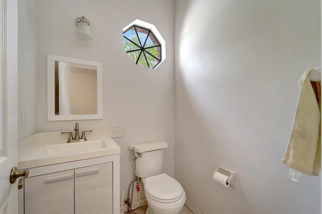 8040 Conservatory Circle Sarasota, FL 34243 - Photo 28 of 52 a bathroom with a toilet sink vanity and mirror