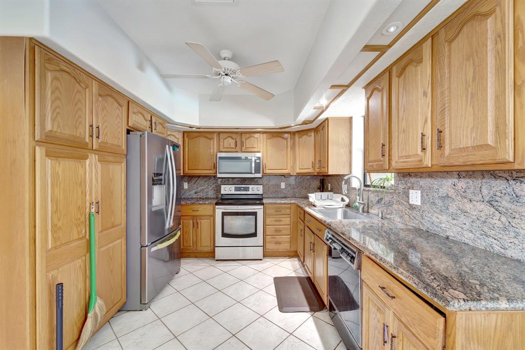8040 Conservatory Circle Sarasota, FL 34243 - Photo 33 of 52 a kitchen with a sink cabinets and stainless steel appliances