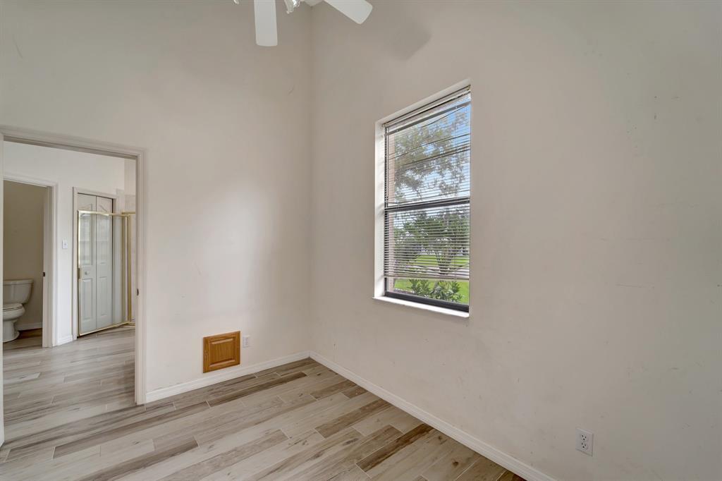 8040 Conservatory Circle Sarasota, FL 34243 - Photo 35 of 52 an empty room with wooden floor and windows