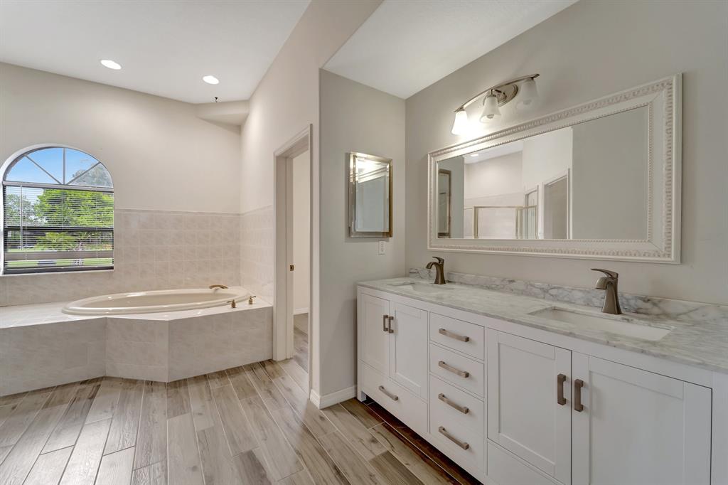 8040 Conservatory Circle Sarasota, FL 34243 - Photo 37 of 52 a bathroom with a tub double vanity sink and mirror