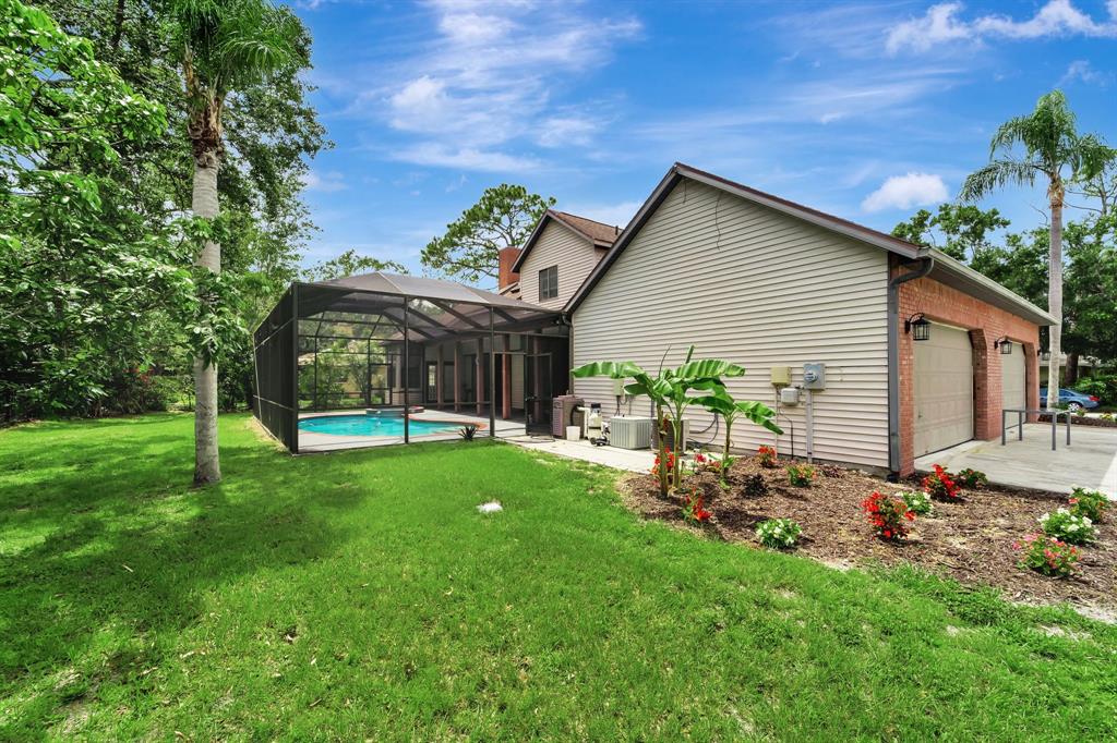 8040 Conservatory Circle Sarasota, FL 34243 - Photo 43 of 52 a view of a house with backyard and sitting area