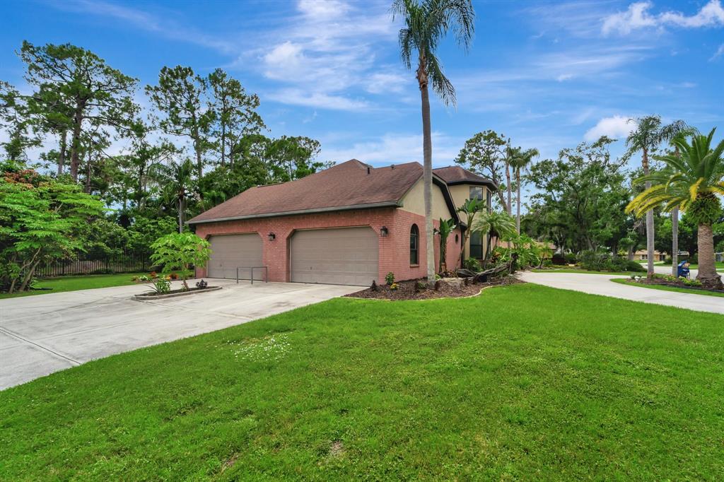 8040 Conservatory Circle Sarasota, FL 34243 - Photo 44 of 52 a view of a house with backyard and a tree