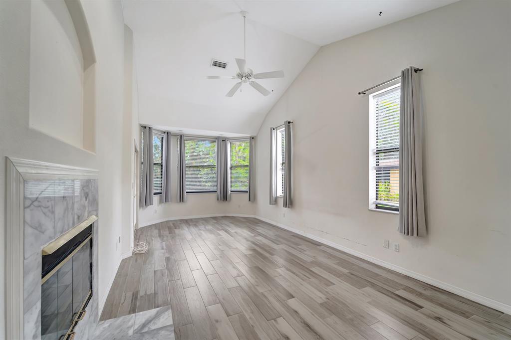 8040 Conservatory Circle Sarasota, FL 34243 - Photo 9 of 52 a view of an empty room with wooden floor and a window
