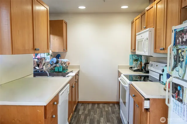 a kitchen with stainless steel appliances a sink and a microwave