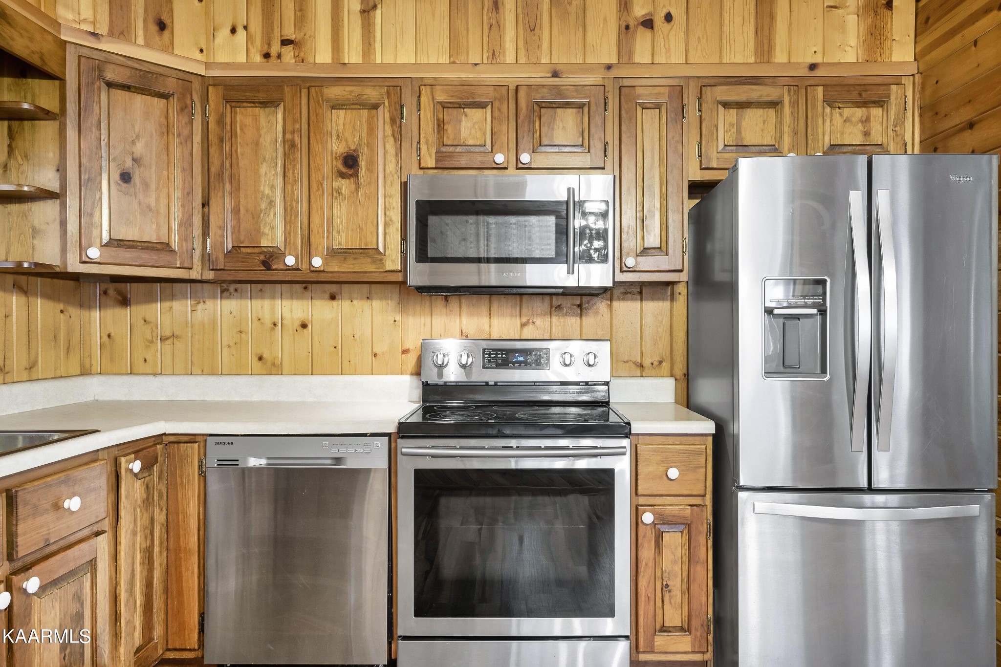 3390 Rocky Ridge Road Cosby, TN 37722 - Photo 36 of 45 a kitchen with stainless steel appliances granite countertop a refrigerator a stove and a microwave with granite countertops