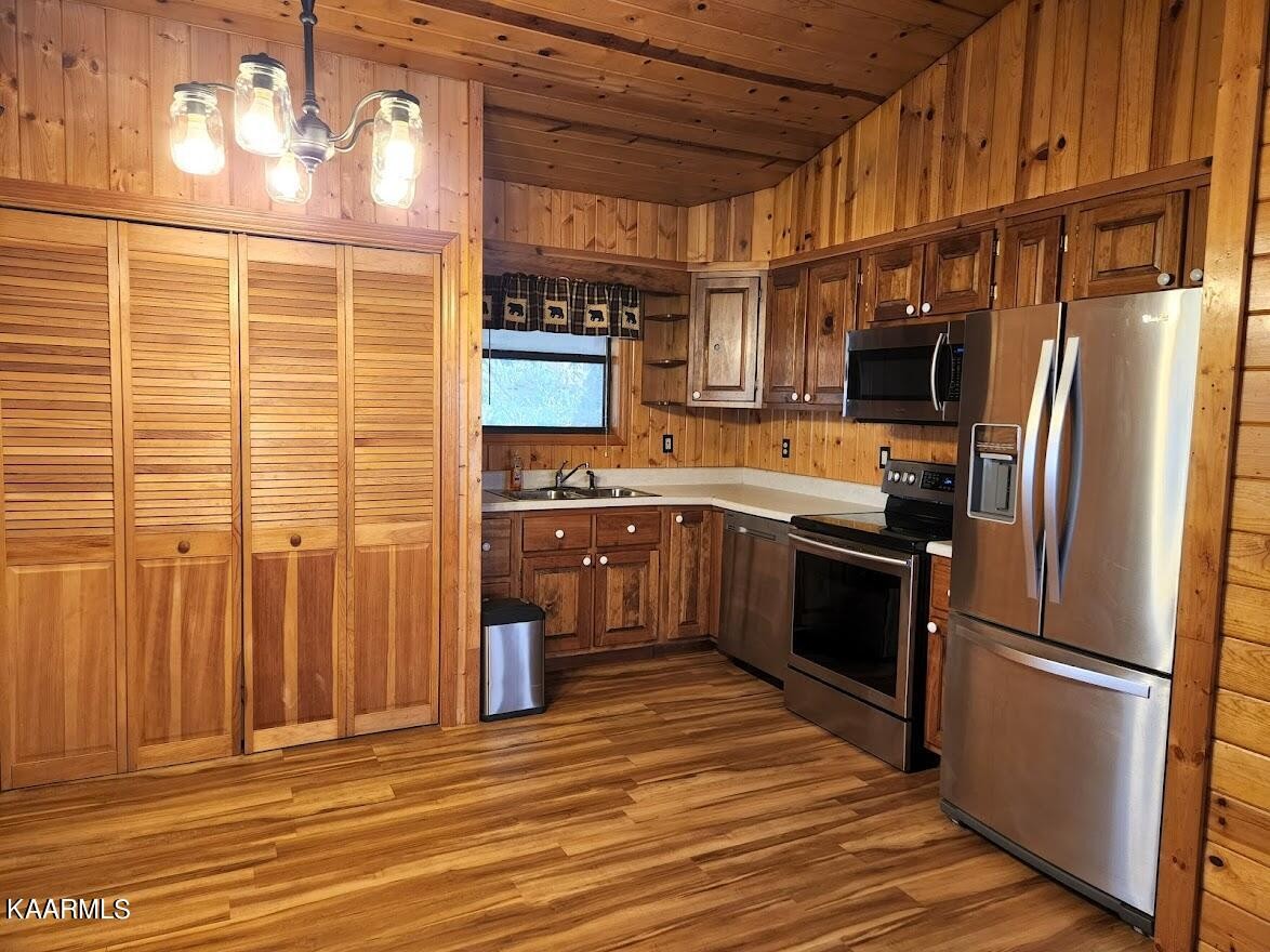 3390 Rocky Ridge Road Cosby, TN 37722 - Photo 10 of 45 a kitchen with stainless steel appliances granite countertop a refrigerator a sink dishwasher a stove and a refrigerator with wooden floor