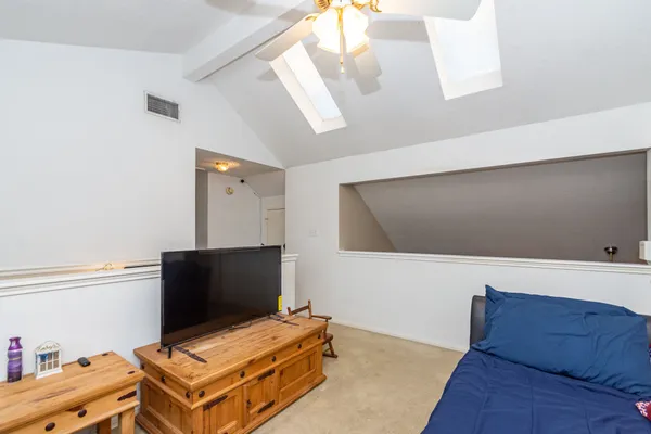 a bedroom with furniture and flat screen tv