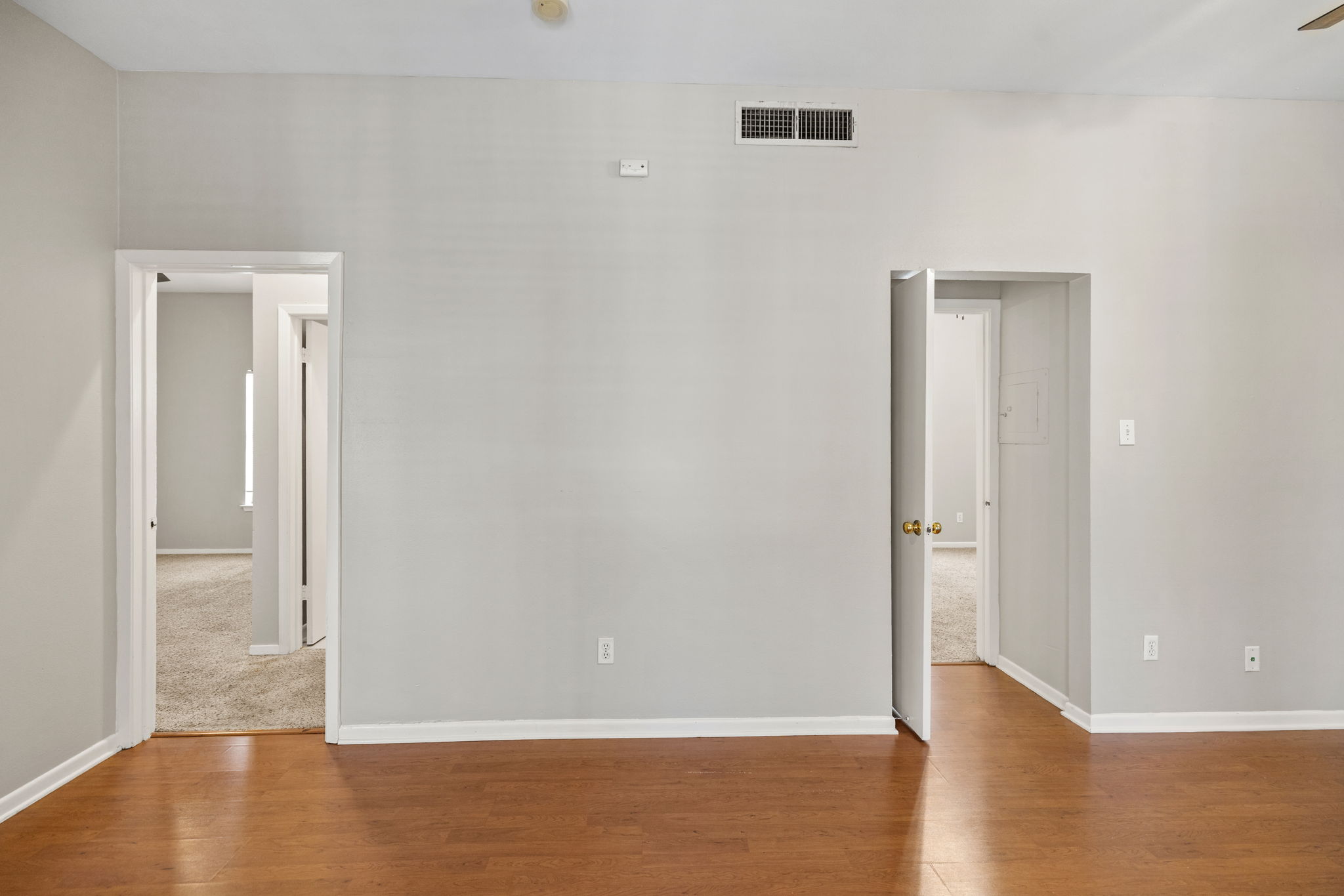 712 Graham Place, Unit 203 Austin, TX 78705 - Photo 6 of 30 an empty room with wooden floor & windows