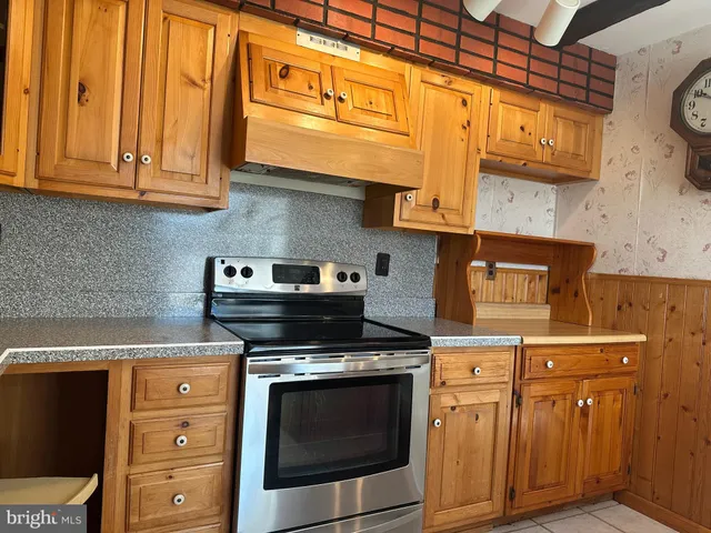 a kitchen with stainless steel appliances granite countertop a stove and a microwave