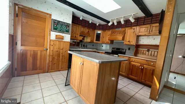 a kitchen with stainless steel appliances a refrigerator and a stove