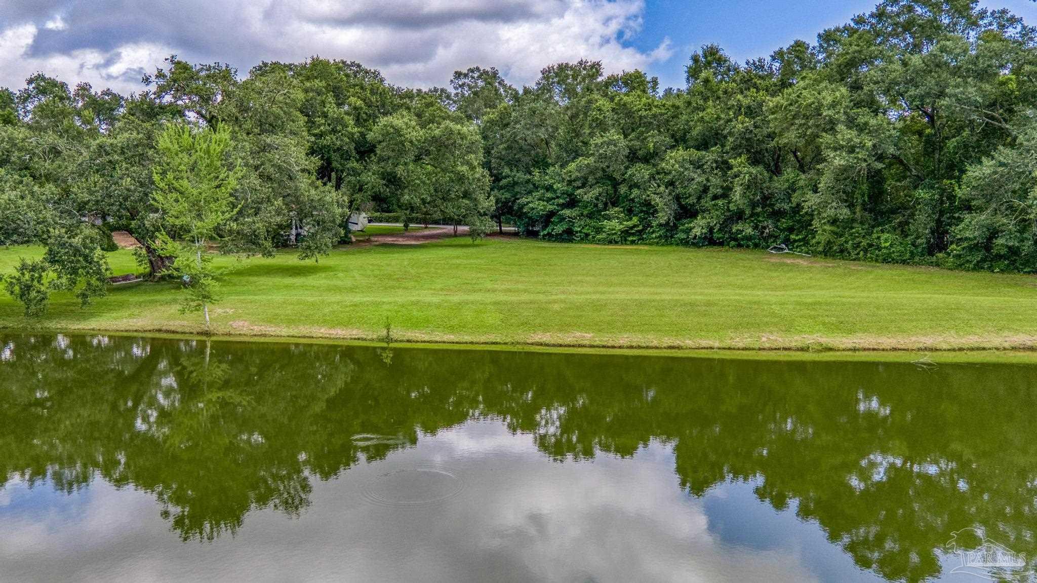 2345 Pompano Street Cantonment, FL 32533 - Photo 35 of 48 a view of a swimming pool with a yard