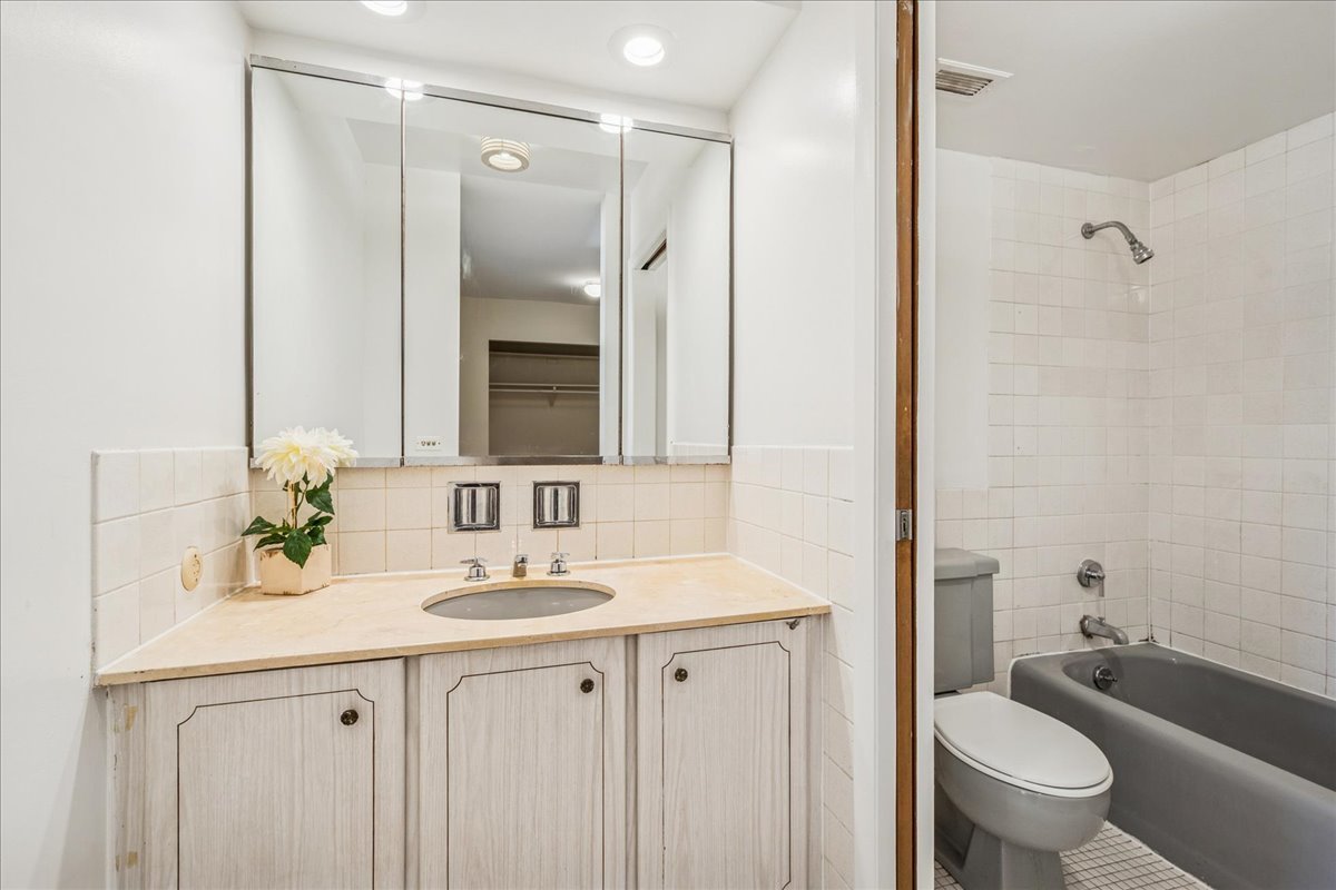 828 Oakton Street, Unit 3F Evanston, IL 60202 - Photo 18 of 21 a bathroom with a granite countertop sink toilet and shower