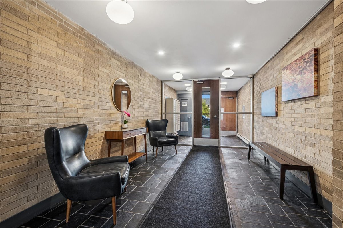 828 Oakton Street, Unit 3F Evanston, IL 60202 - Photo 2 of 21 a living room with furniture a flat screen tv and a fireplace